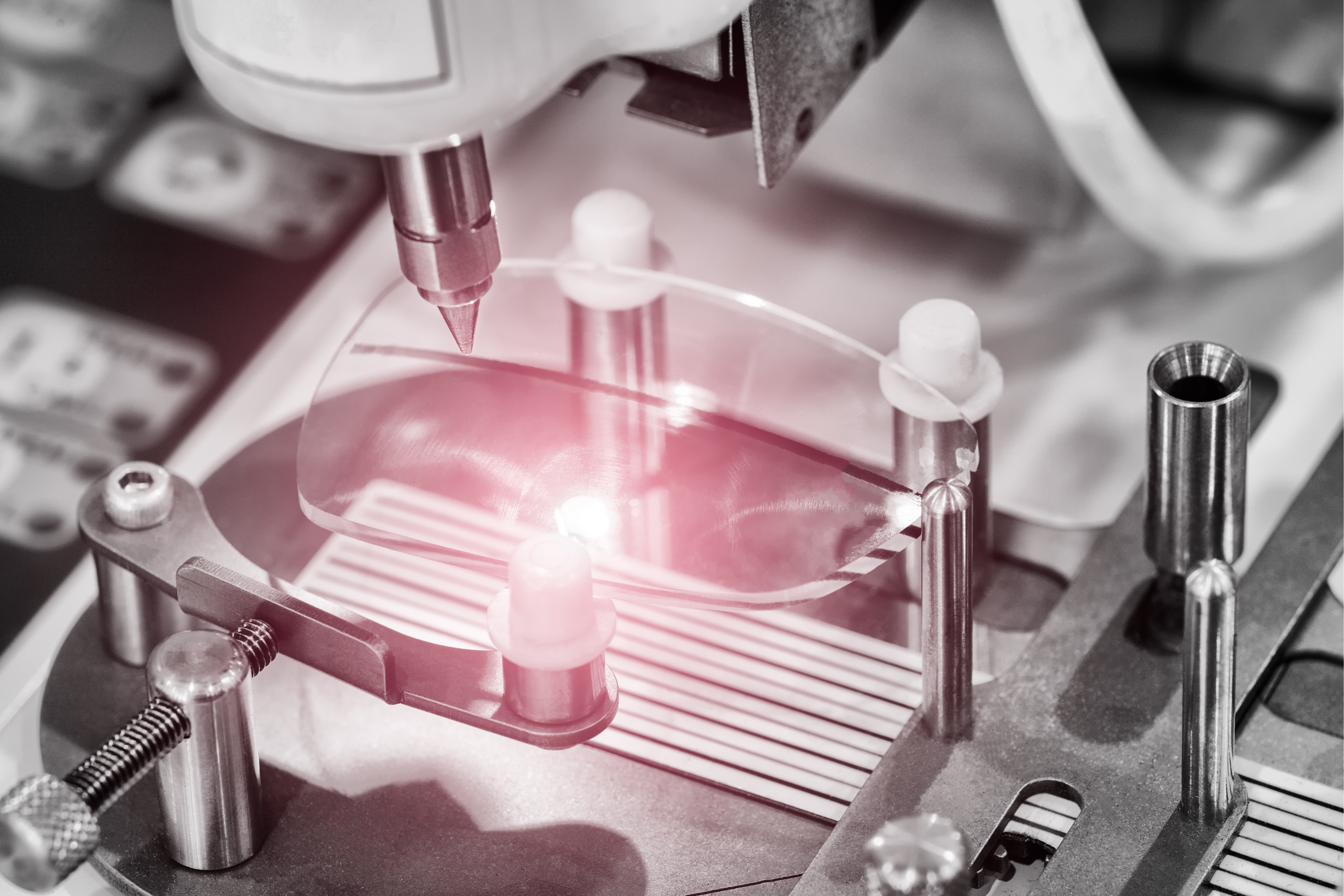 An eyeglass lens being manufactured.