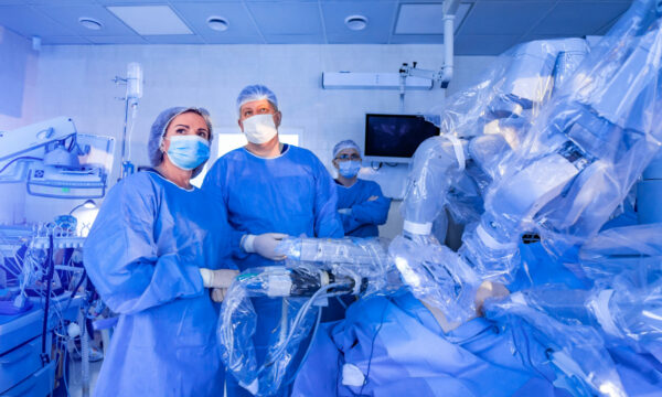 Surgeons operating using a surgical robot.